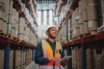 Warehouse worker scanning a durable barcode label on an inventory bin | How to Implement a Barcode System in a Warehouse